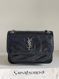 YSL dark leather shoulder bag with YSL logo on front flap and chain strap
