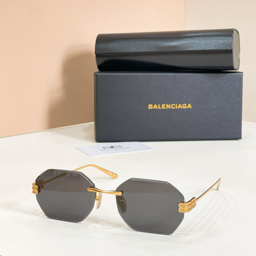 Octagonal sunglasses with gold frame and dark gray lenses