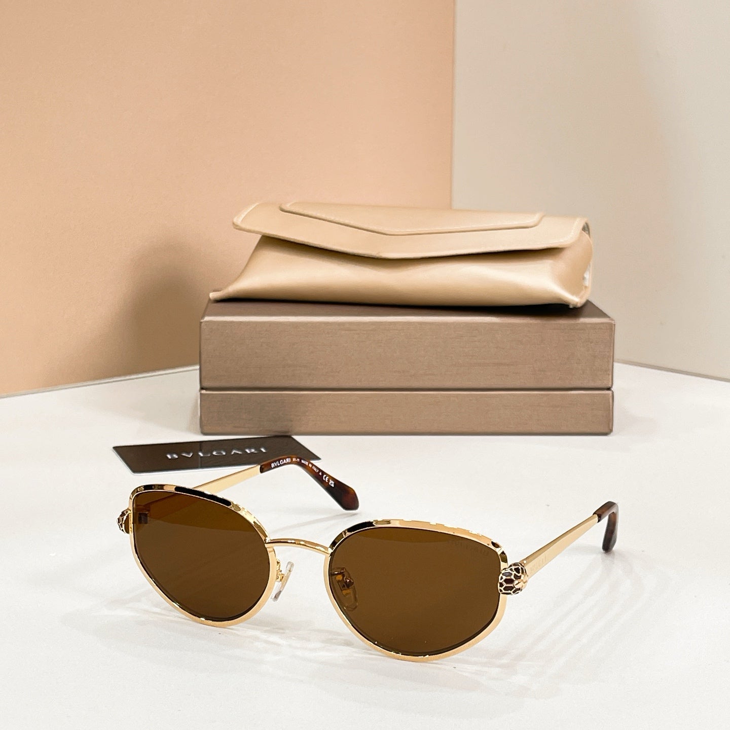 Bvlgari cat-eye sunglasses with amber lenses and gold-tone frame