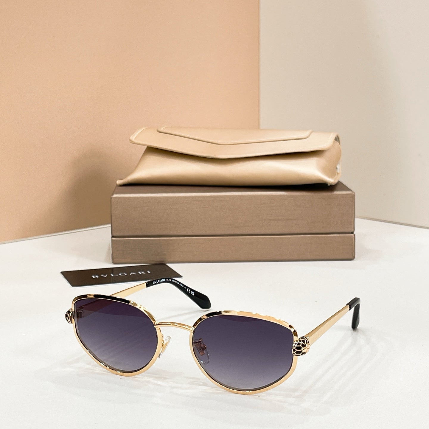 Bvlgari cat-eye sunglasses with dark purple lenses and gold-tone frame
