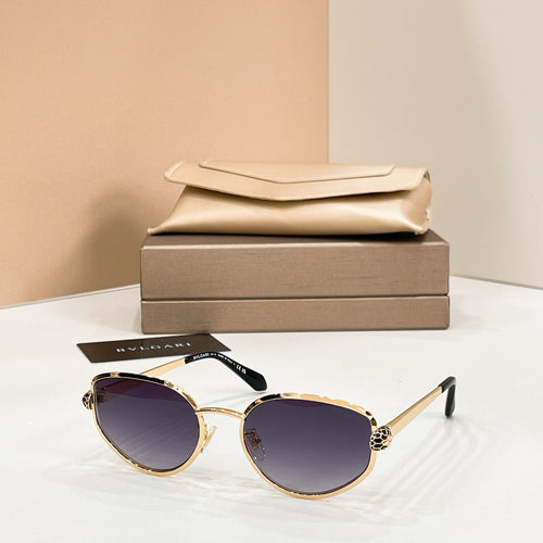 Bvlgari cat-eye sunglasses with dark purple lenses and gold-tone frame