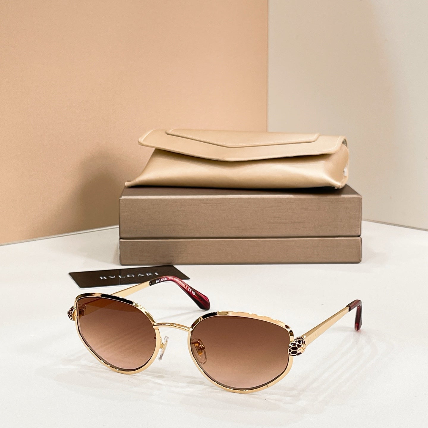 Bvlgari cat-eye sunglasses with warm brown lenses and gold-tone frame