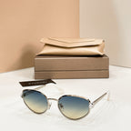 Bvlgari cat-eye sunglasses with blue-tinted lenses and gold-tone frame