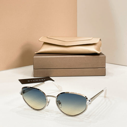 Bvlgari cat-eye sunglasses with blue-tinted lenses and gold-tone frame