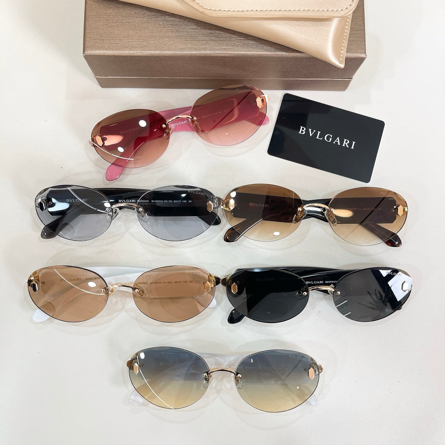 Assorted Bvlgari sunglasses with multiple frames and tinted round lenses on display