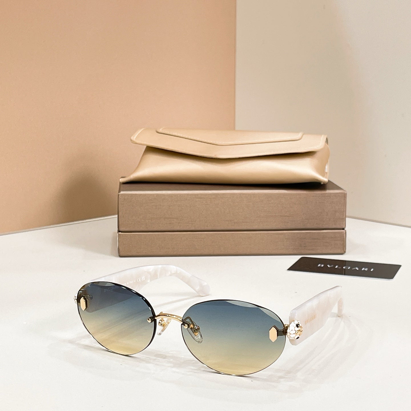 Bvlgari sunglasses with white frame and blue-tinted round lenses