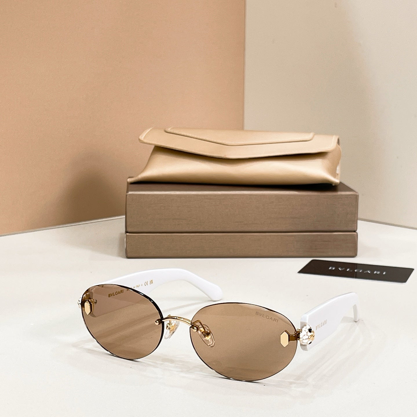 Bvlgari sunglasses with white frame and light brown tinted round lenses