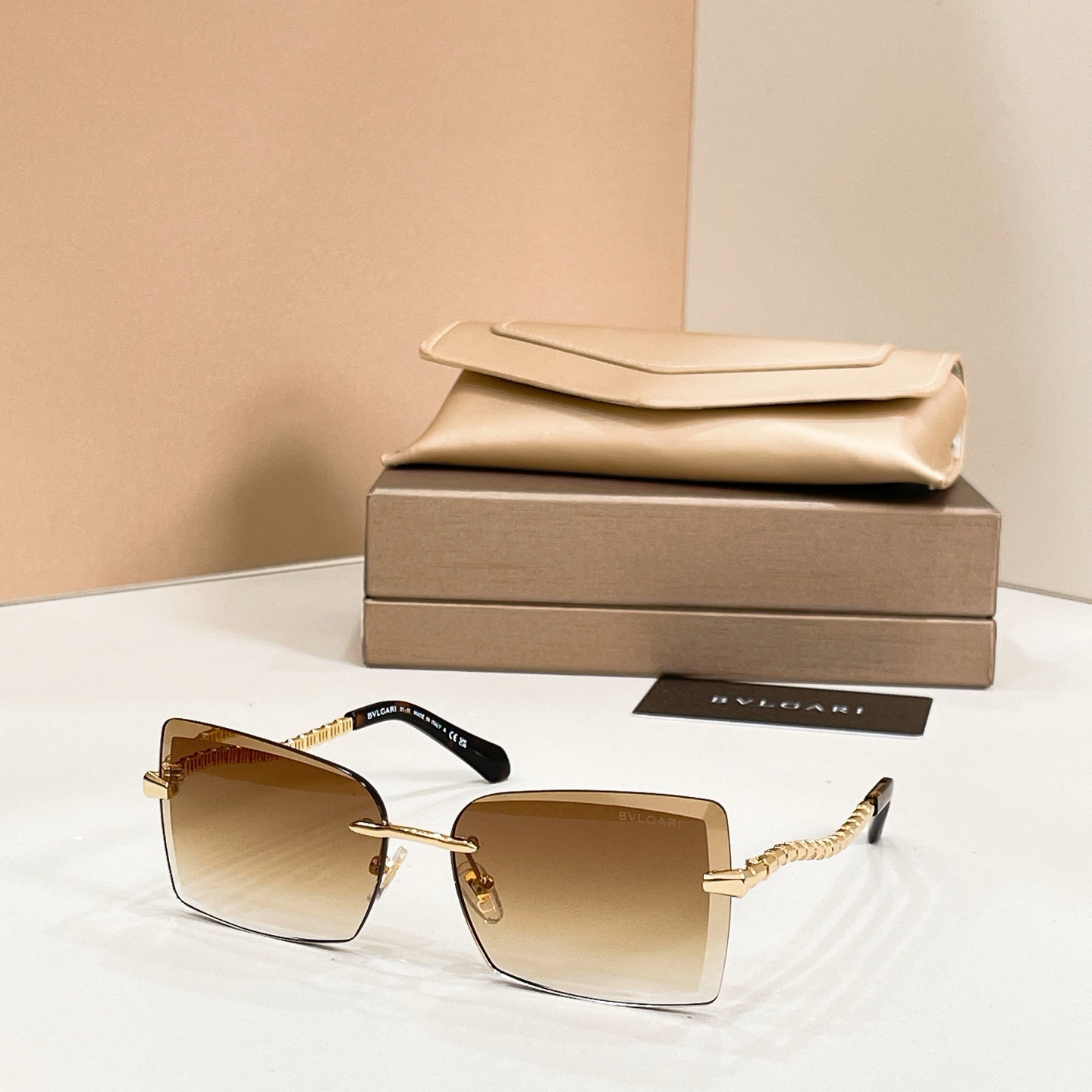Bvlgari square sunglasses with dark tan frames and gold bar temples
