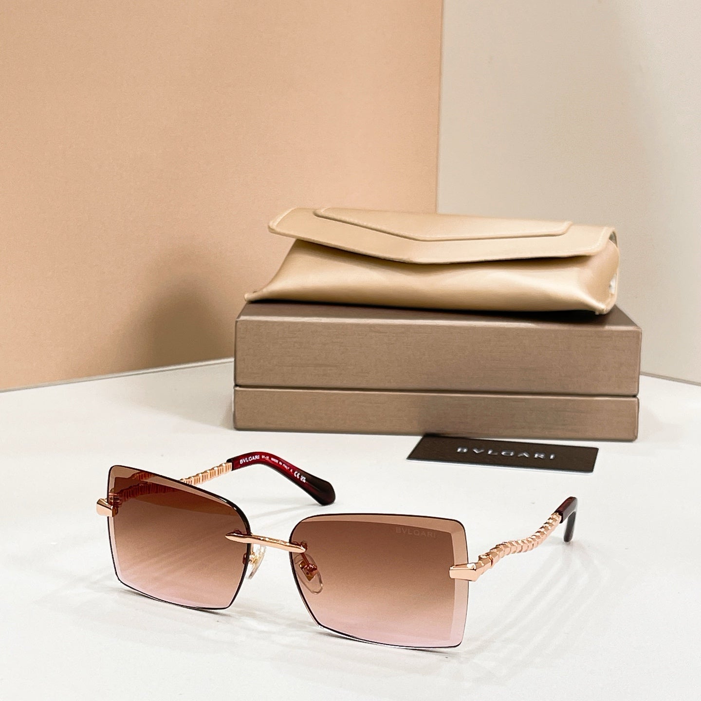 Bvlgari square sunglasses with burgundy frames and gold bar temples