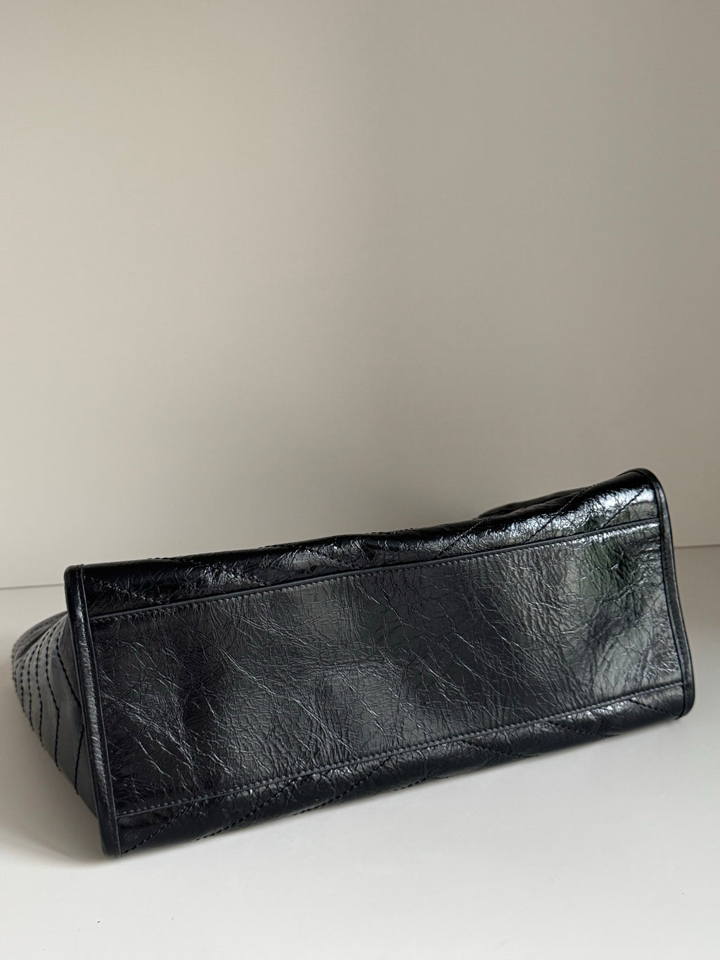 Black leather slim pouch with textured surface and top edge seam