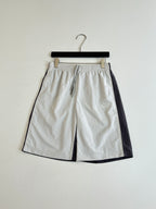 White drawstring waist shorts with pleats and side seam pockets