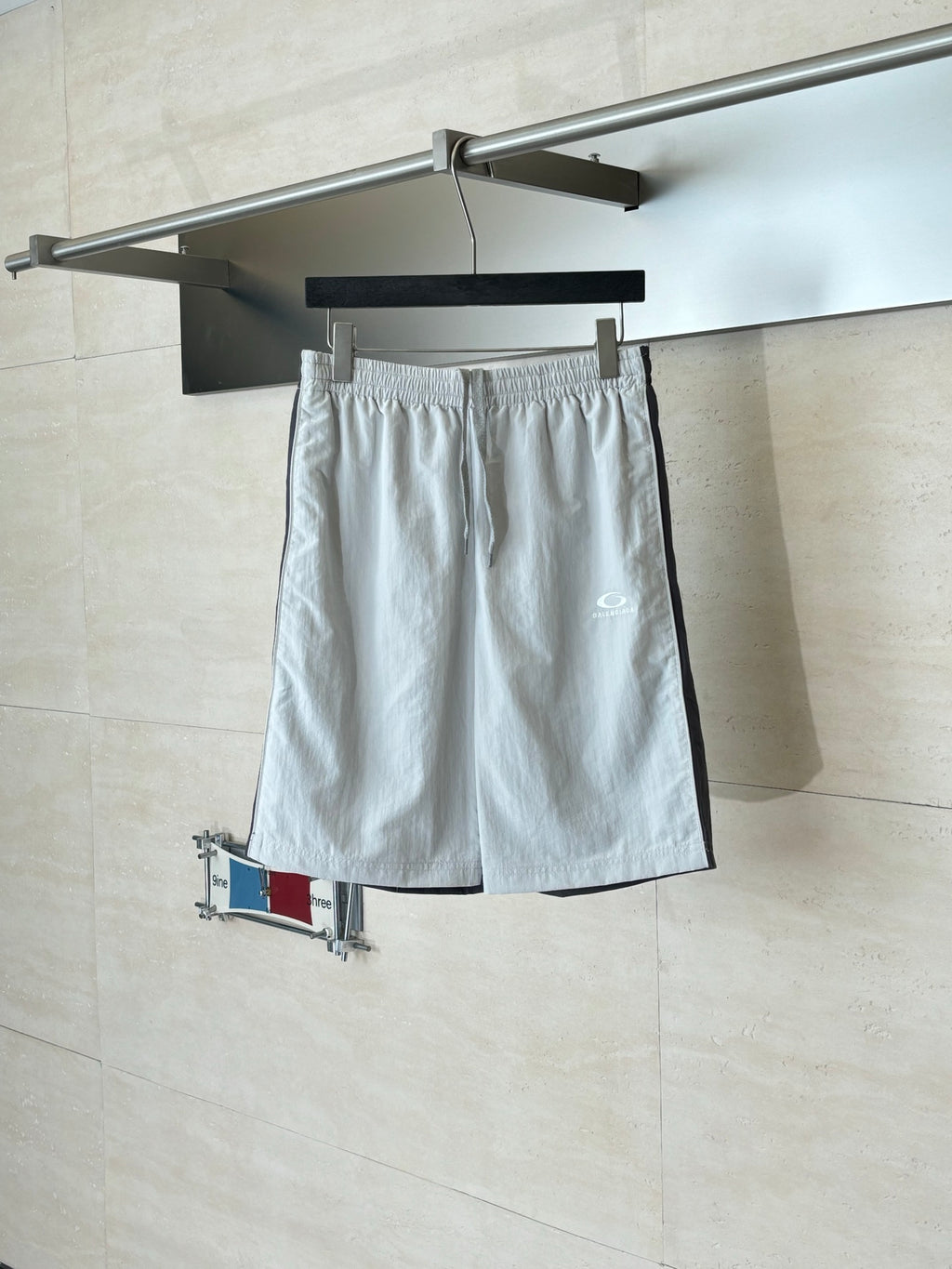 White drawstring waist shorts with side pockets and small logo patch