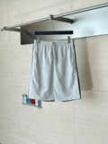 White drawstring waist shorts with side pockets and small logo patch