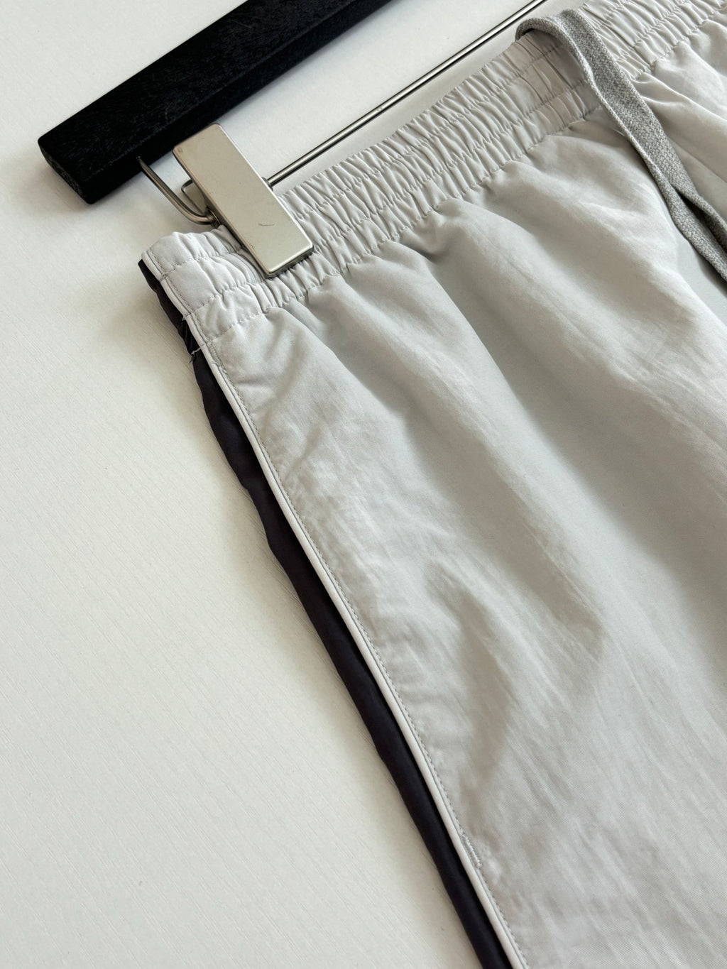 White shorts close-up: gathered waistband and side pocket opening