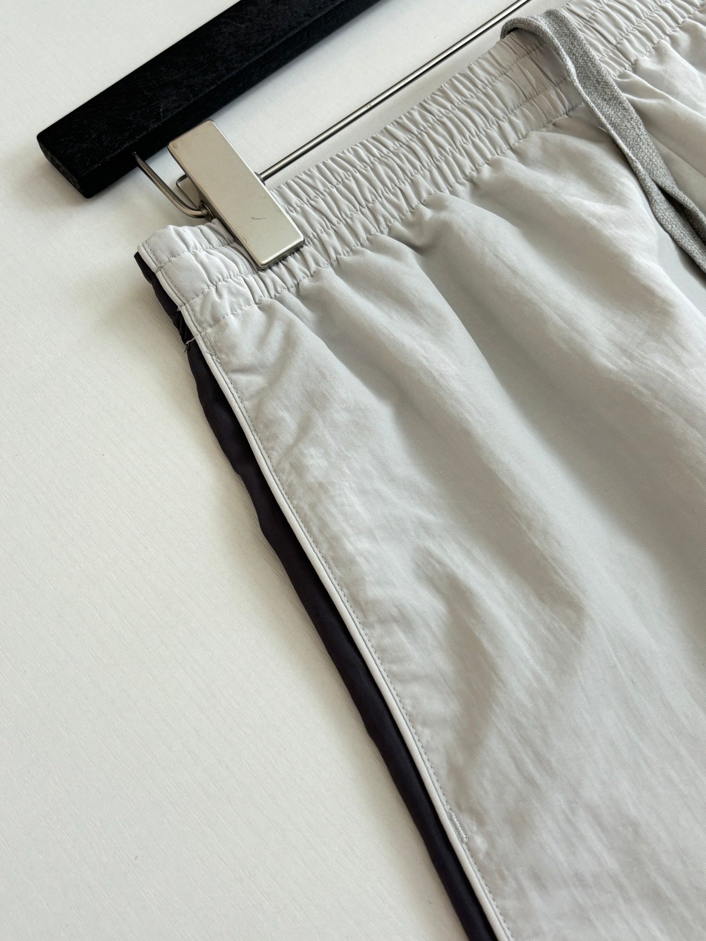 White shorts close-up: gathered waistband and side pocket opening