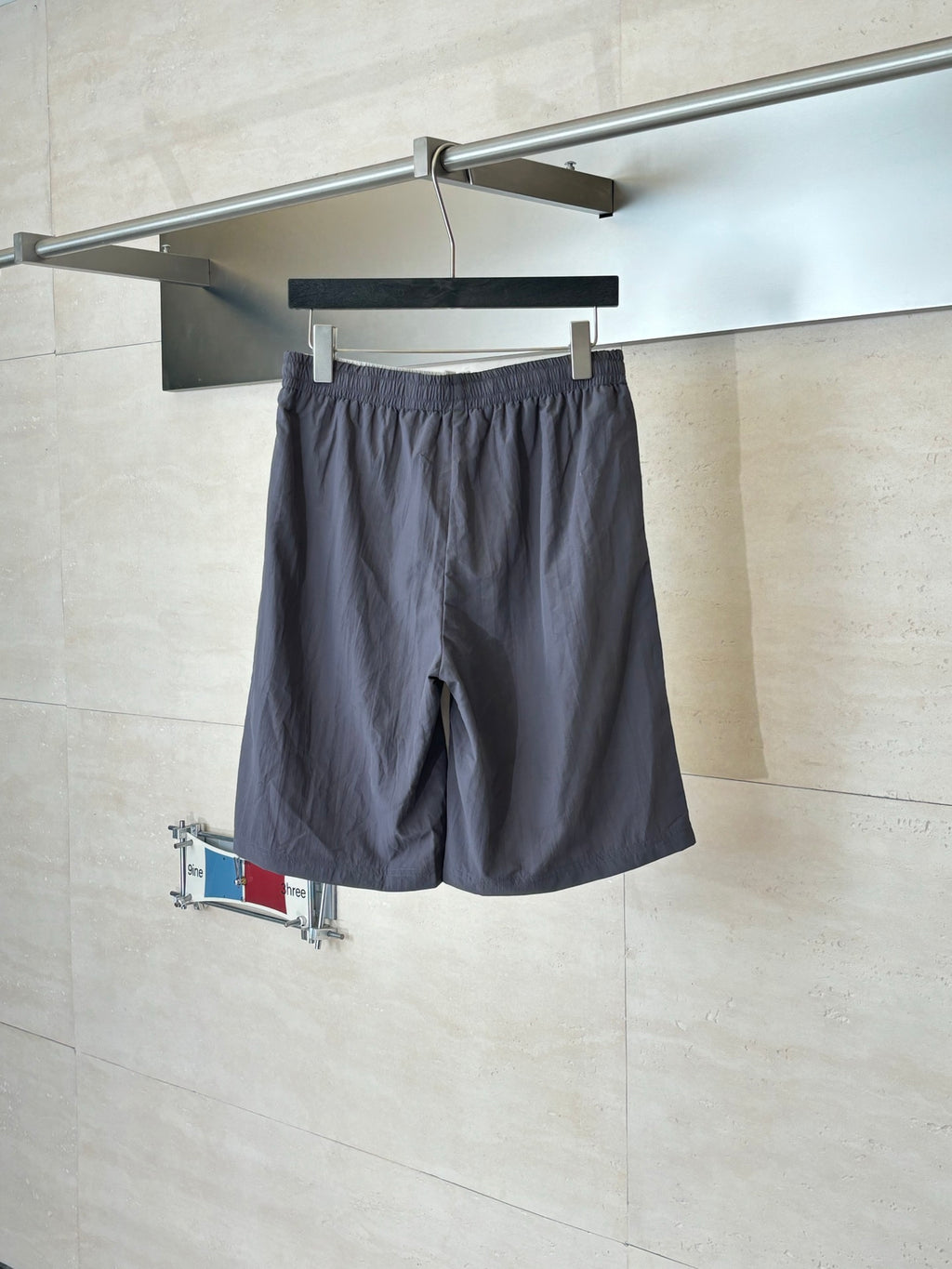 Dark navy drawstring waist shorts with side pockets and small logo patch