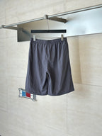 Dark navy drawstring waist shorts with side pockets and small logo patch