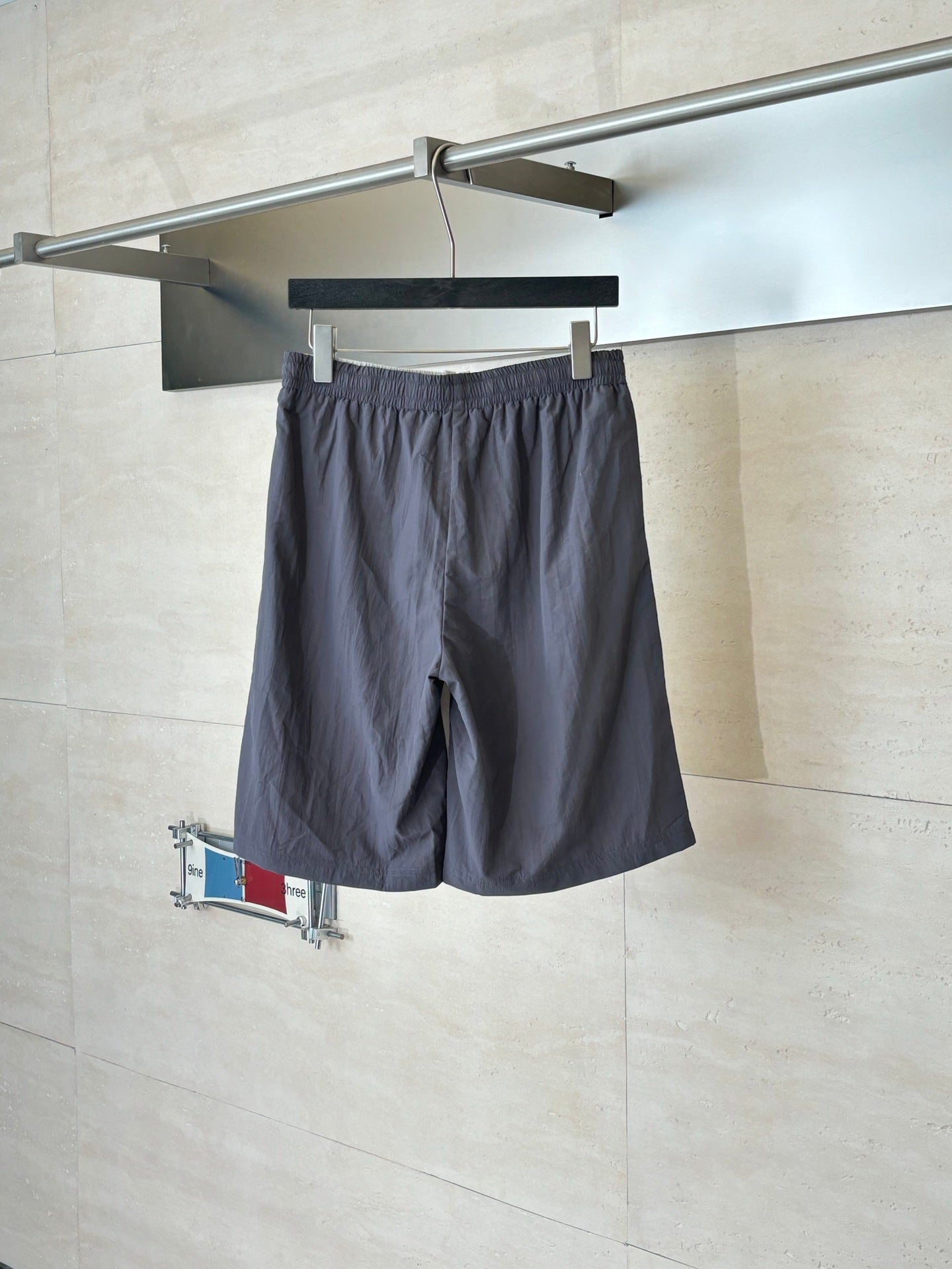 Dark navy drawstring waist shorts with side pockets and small logo patch
