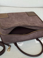 Loewe brown leather handbag with open top, gold-tone zipper, and inner pocket lining