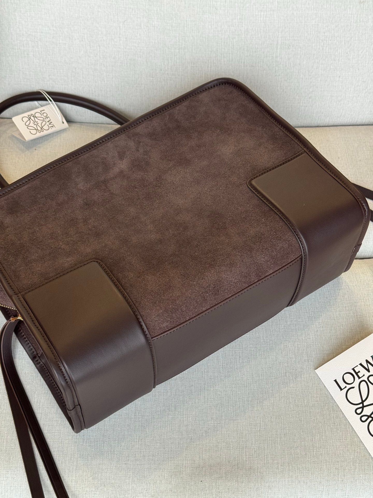 Loewe brown leather handbag with boxy shape, contrast trim panels, and top handle