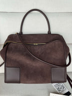 Loewe brown leather handbag with top handles, side zip pocket, and crossbody strap