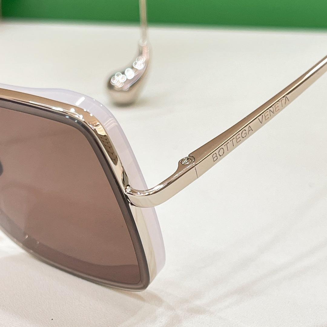 Bottega Veneta sunglasses temple with engraved logo and gold hinge hardware