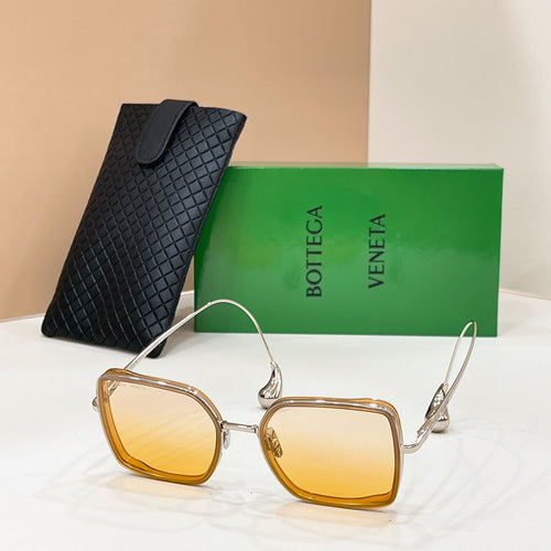 Bottega Veneta sunglasses with gold frame and amber tinted square lenses