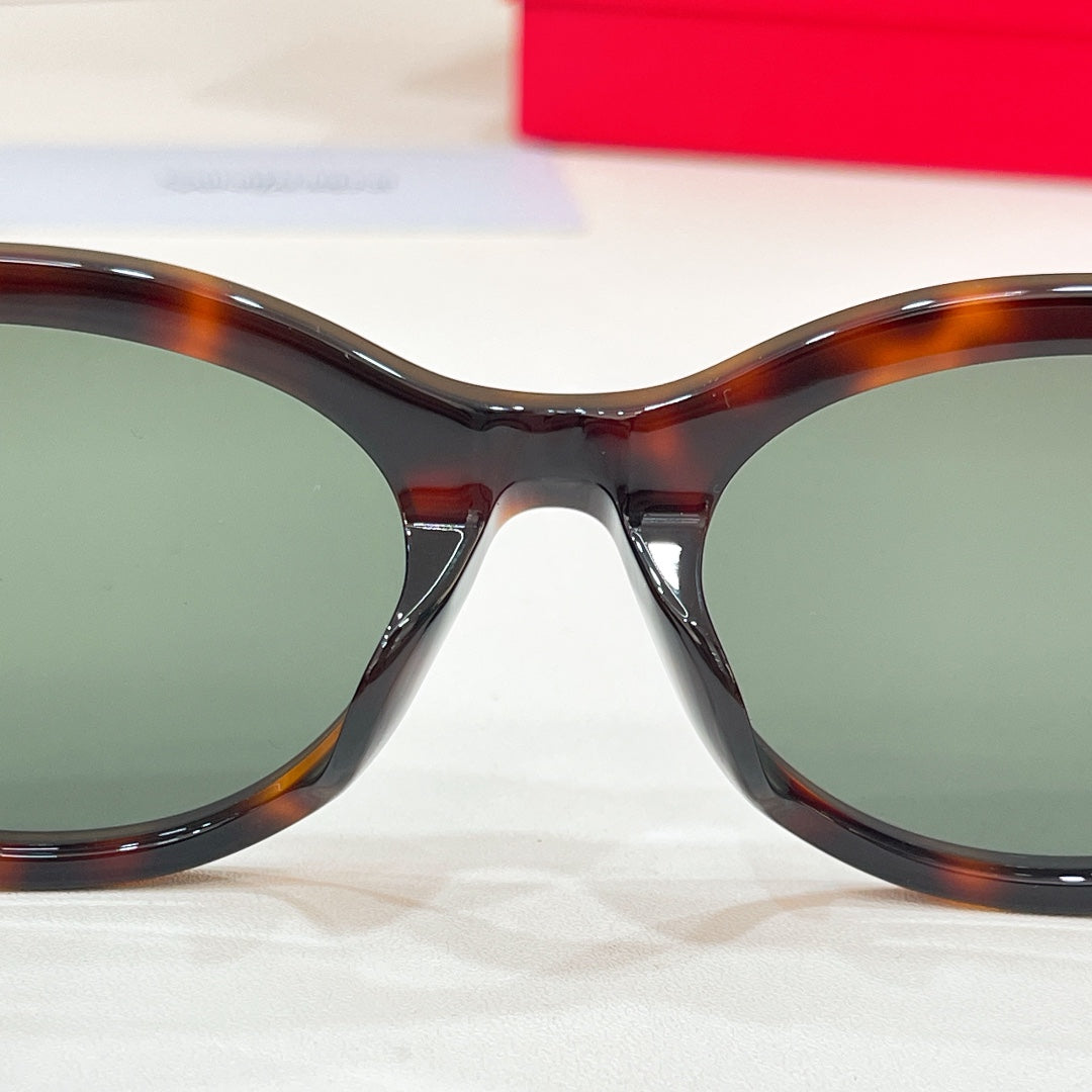 Tortoiseshell cat-eye sunglasses front view with dark green tinted lenses