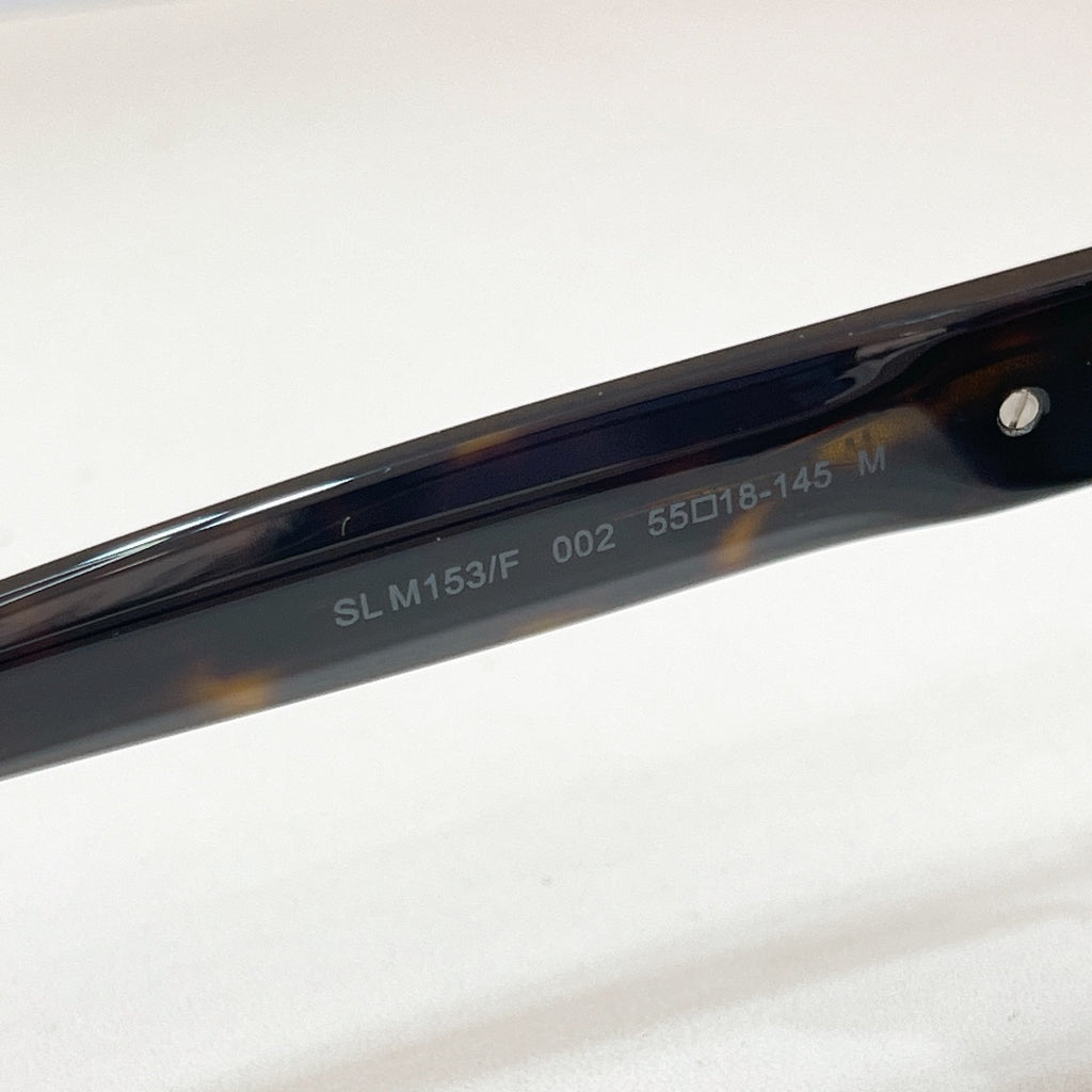 SL M153F temple arm on dark cat-eye sunglasses with glossy black frame