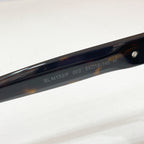SL M153F temple arm on dark cat-eye sunglasses with glossy black frame