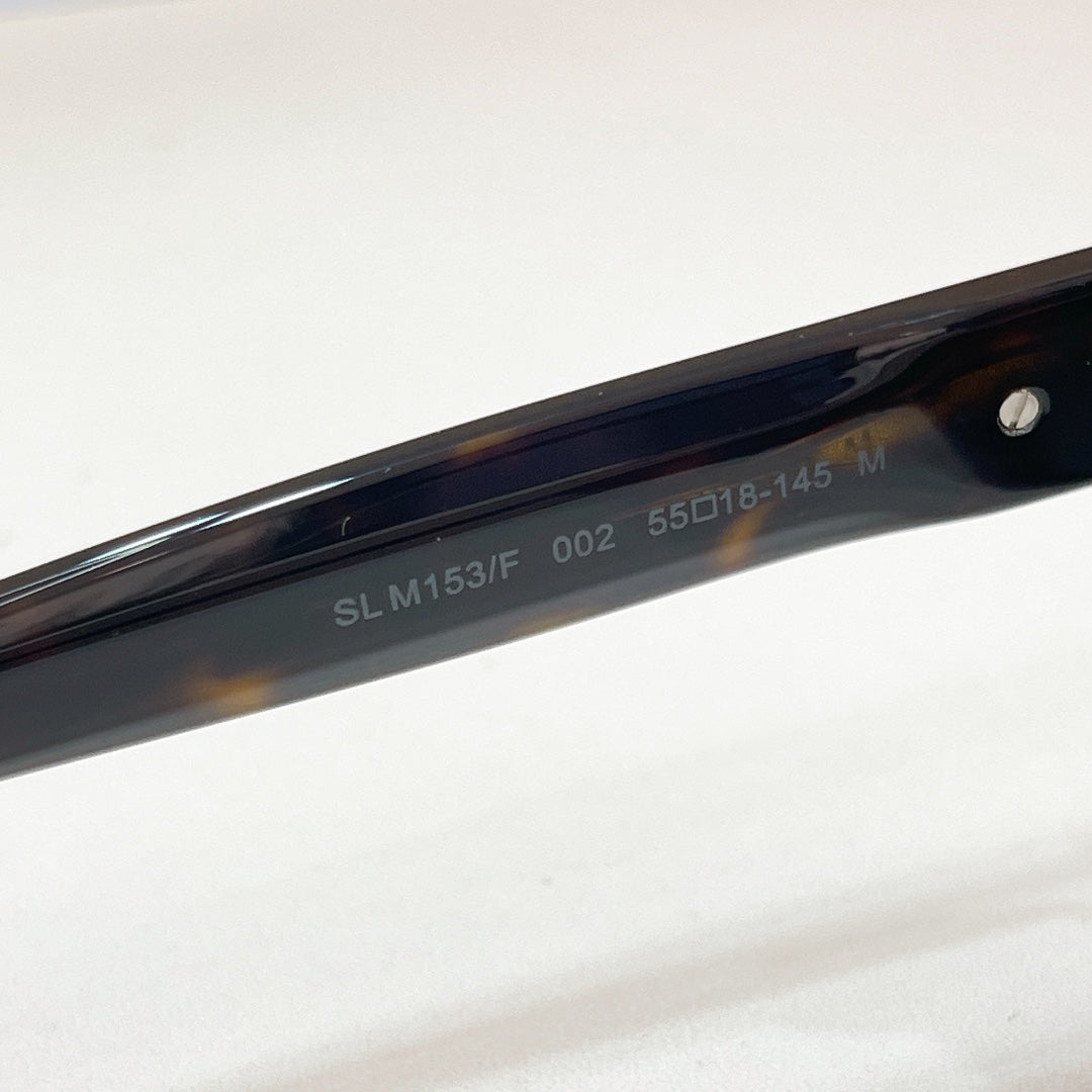 SL M153F temple arm on dark cat-eye sunglasses with glossy black frame