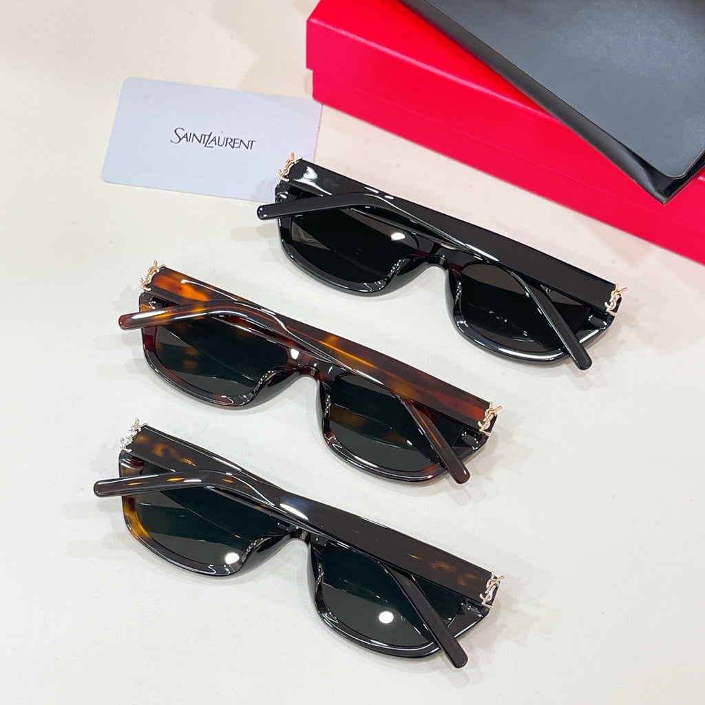 Cat-eye sunglasses set with black and tortoiseshell frames, dark lenses, metal hinges