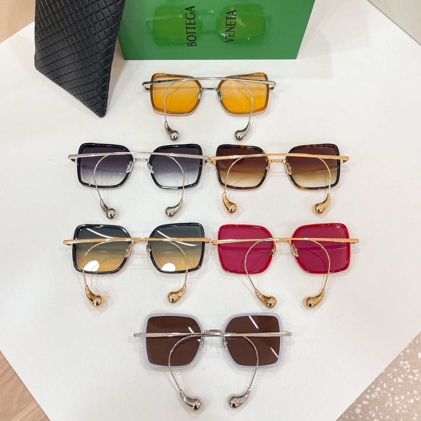 Assorted Bottega Veneta sunglasses lineup with gold frames and tinted square lenses