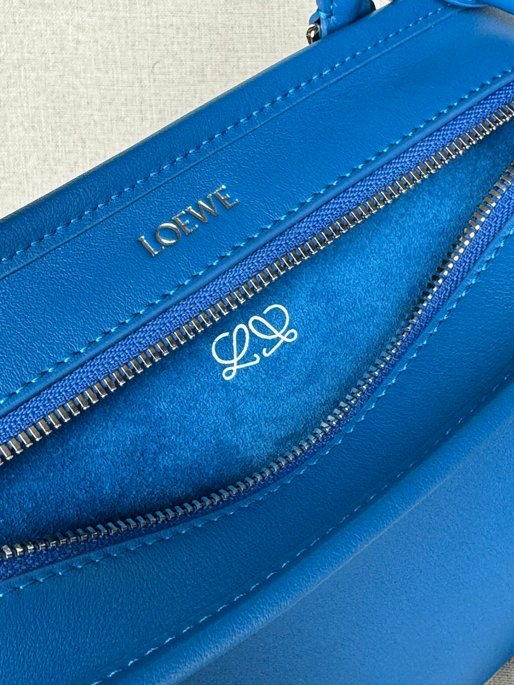 Loewe blue leather bag close-up of LOEWE logo and double zip pullers