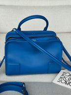 Loewe blue leather top-handle bag with adjustable crossbody strap and zip top