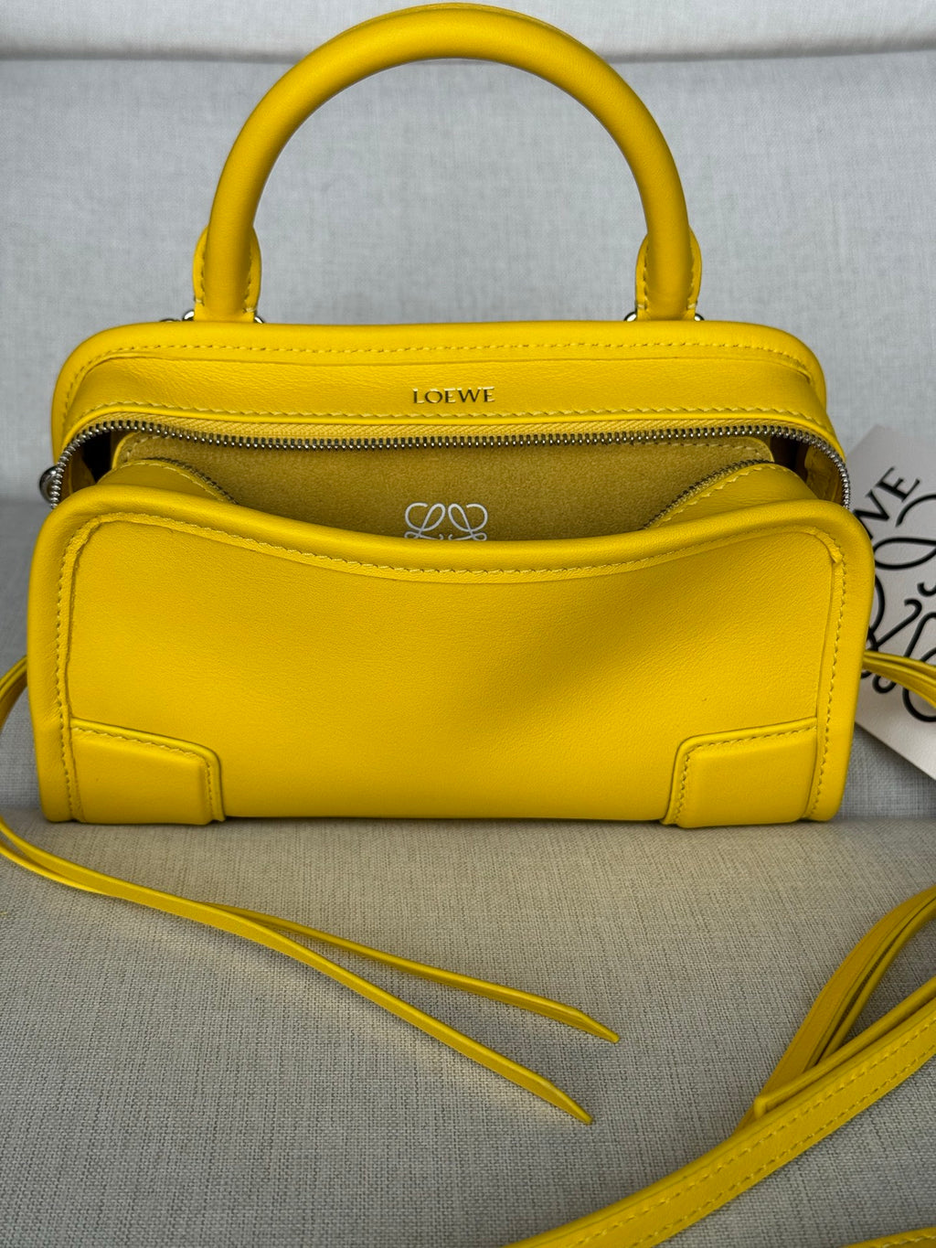 Yellow leather small top-handle bag with zipper top and crossbody strap