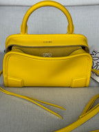 Yellow leather small top-handle bag with zipper top and crossbody strap