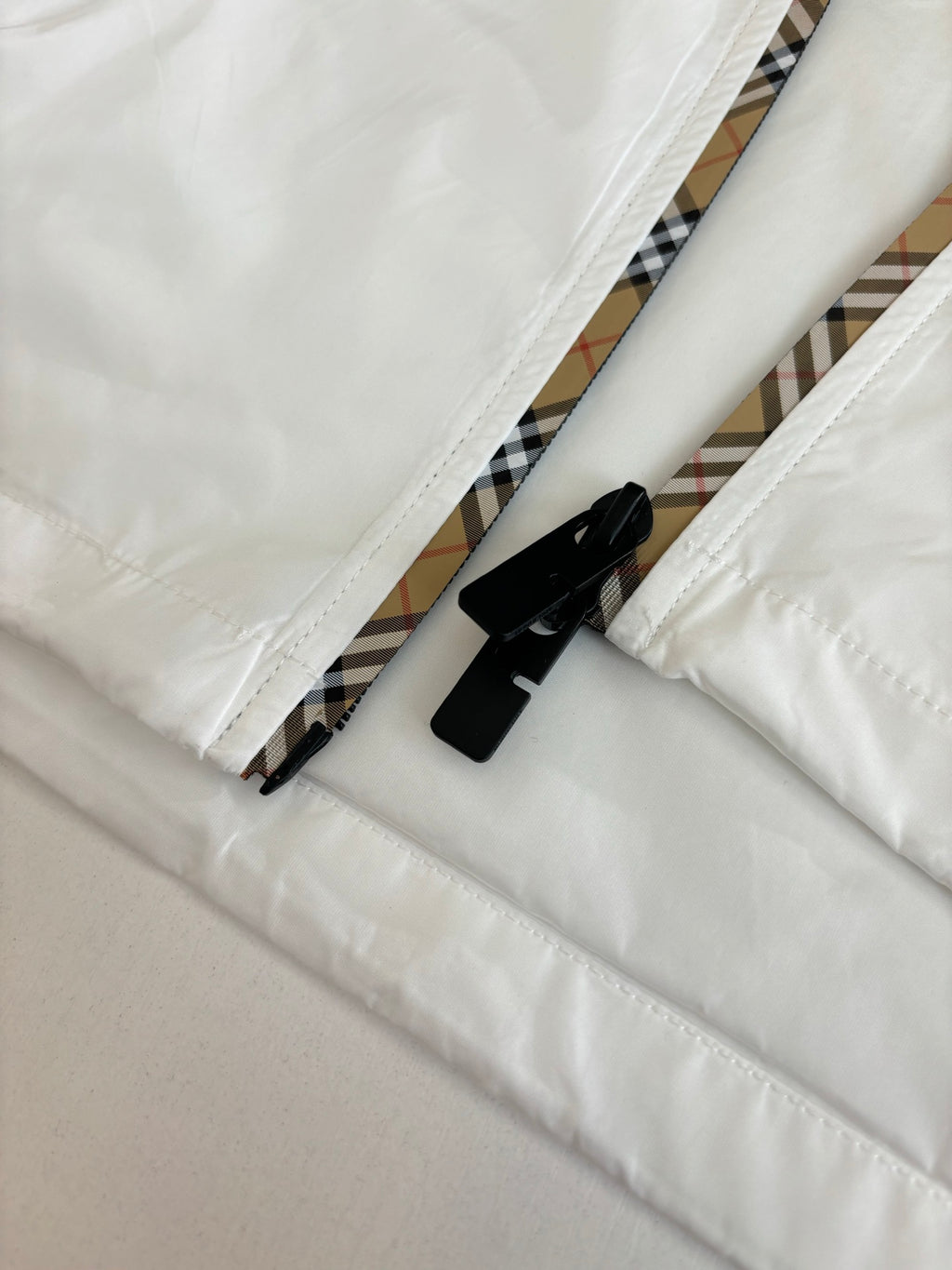 Burberry jacket close-up: black trim on inner hem and zipper tape