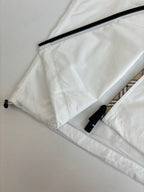 Burberry white hooded jacket close-up: black zipper tape and drawcord tips