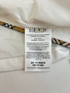 Burberry tag and fabric label on inside of white jacket