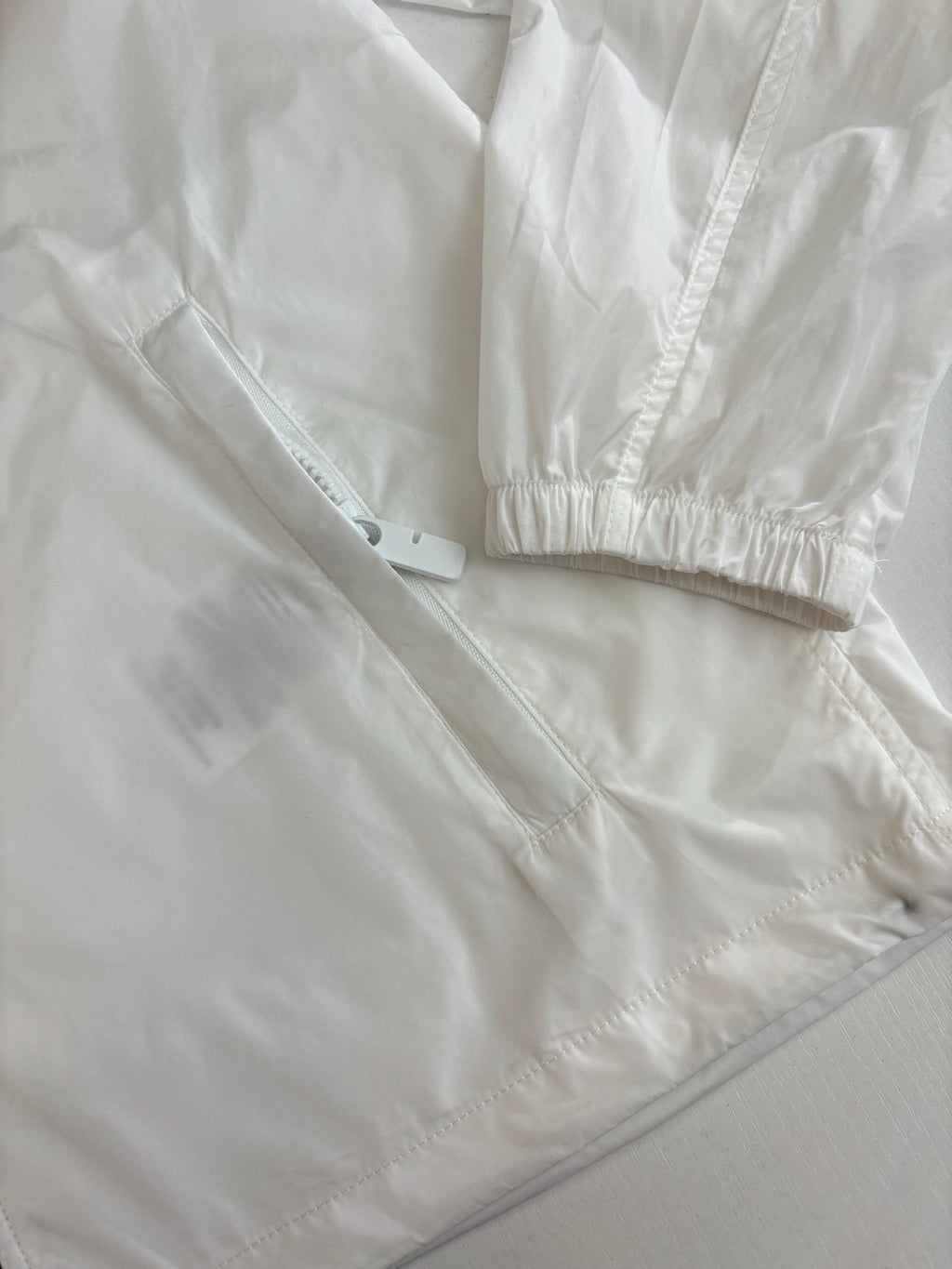 Burberry white jacket close-up: cuffs and hem with subtle seam lines