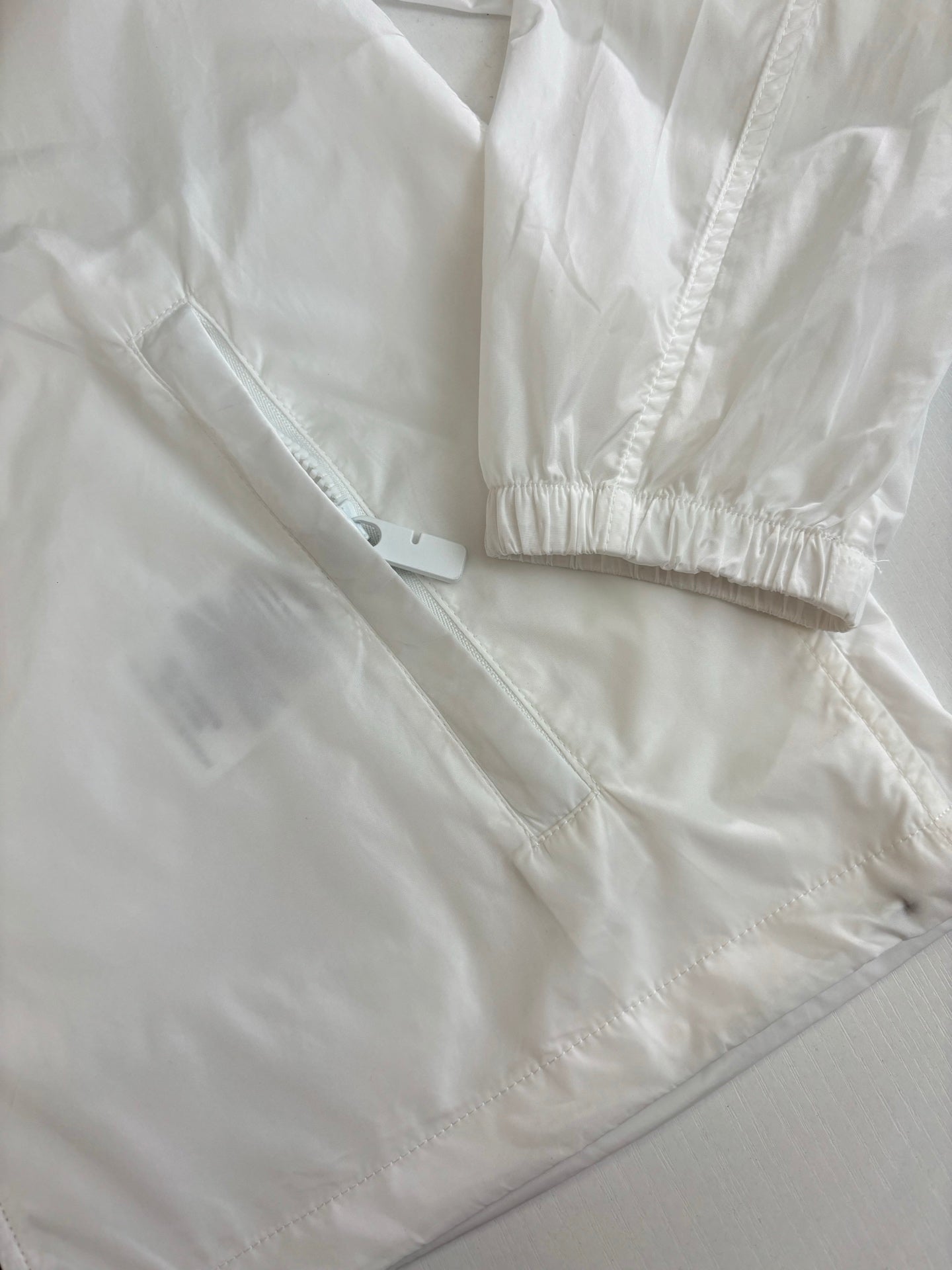 Burberry white jacket close-up: cuffs and hem with subtle seam lines