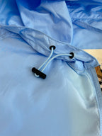 Blue hooded jacket with drawstring and black toggle detail