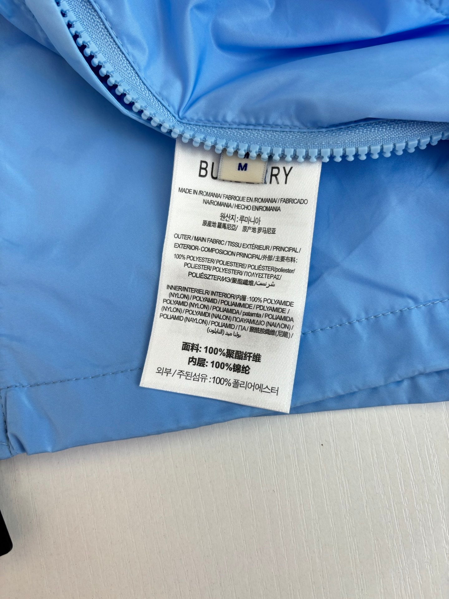 Burberry long jacket care label on light blue fabric