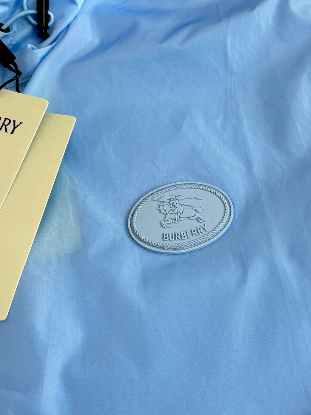 Blue jacket with oval stitched Burberry logo patch