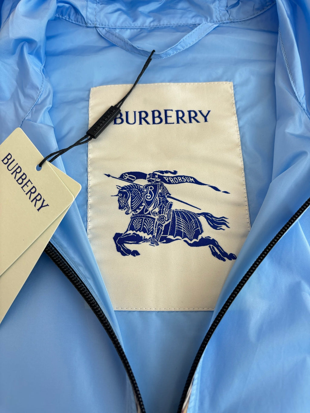 Blue jacket chest panel with BURBERRY text and knight graphic
