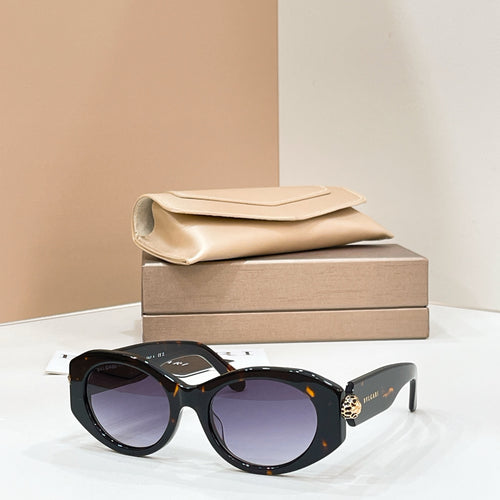 Bvlgari round sunglasses with black frame and dark lenses, gold-toned charm on temple.
