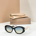 Bvlgari round sunglasses with black frame and light blue-tinted lenses, gold-toned charm.