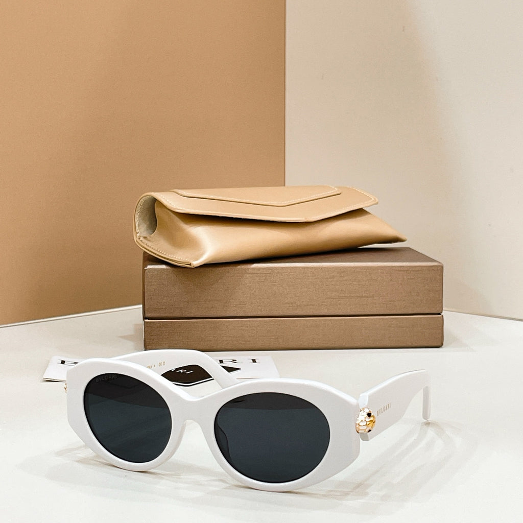 Bvlgari round sunglasses with white frame and dark lenses, gold-toned charm on temple.