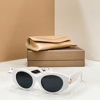 Bvlgari round sunglasses with white frame and dark lenses, gold-toned charm on temple.